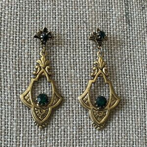 Vintage gold toned ornate drop dangle pierced earrings with green rhinestones.